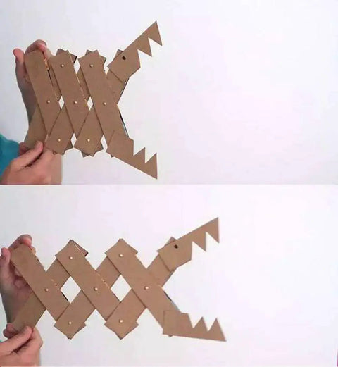 Hand holding DIY cardboard fish decor crafted with 1600 Piece Tiny Nails Wood Screws Set For DIY Crafts Antique Finish.