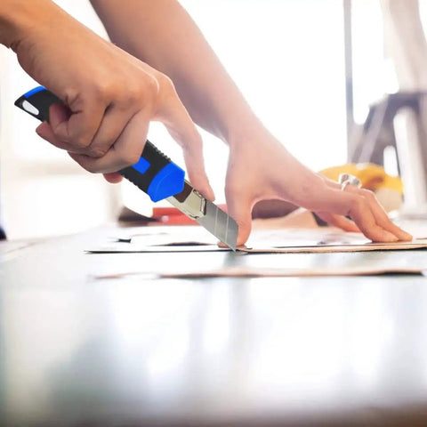 Person using a cutter from 93-Piece Household Tool Kit With Storage Case For Home DIY Projects