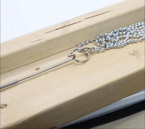 Stainless steel fish ball chain with stop ring on wood, part of Fish Ball Chain 16 Feet With 2 Stop Rings For Hidden Wiring In Narrow Or Inaccessible Wall Spaces.