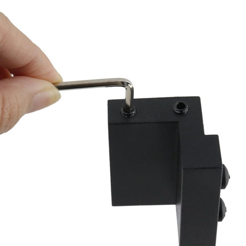 Hand using wrench on Barn Door Roller Stopper Hardware For Track 41x7mm Flat Rail Limit Stop, Rust-Resistant Carbon Steel, Easy Install