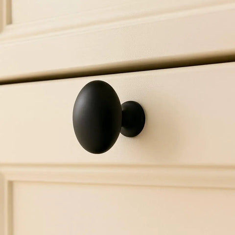 Installed Oval Matte Black Cabinet Knob on drawer 1.27 inch length 1.36 inch height by EAXINTA for modern kitchen and furniture