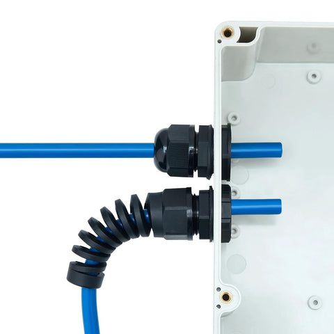 Aandxmok PG7 waterproof cable glands, PA66, two black glands with blue cables installed on a white electrical box