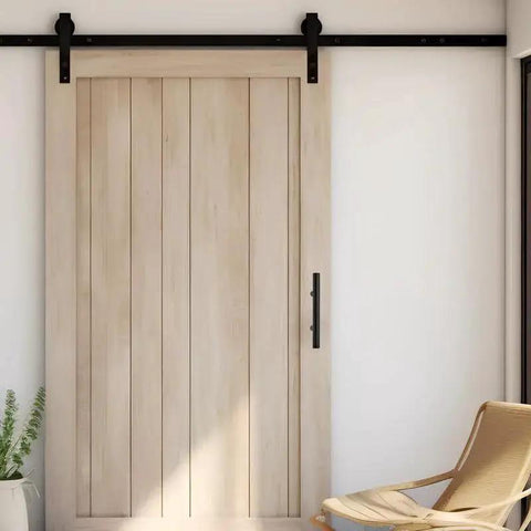 Wooden sliding barn door with matte black handle and track in modern interior