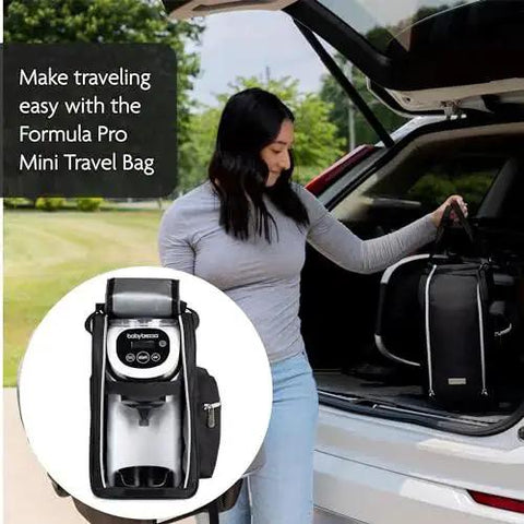 Front view of Baby Brezza Formula Pro Mini travel bag with bottle maker inside; black bag by open car trunk