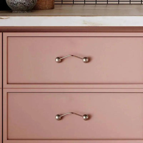 One Pack 5 Inch Titanium Silver Cabinet Handles Ball Tip Pulls With Polished Solid Brass Core And Premium Titanium Silver Finish installed on pink drawers