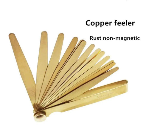 Brass Feeler Gauge Set 0.03 To 1.0 Mm High Precision Clearance Gauge Non Magnetic Copper Feelers splayed out on a white background.