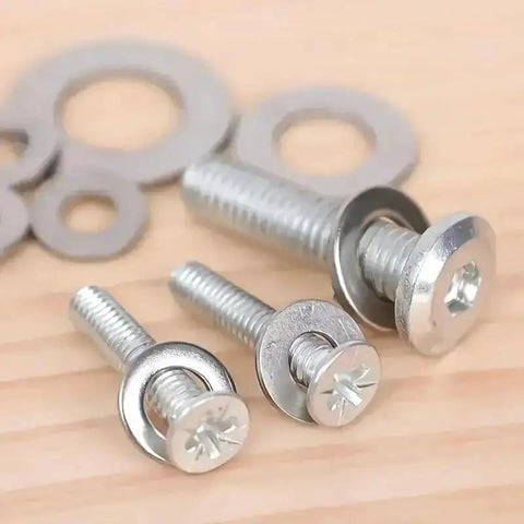 Close-up of screws with 180 Pcs Stainless Steel Flat Washers Set For Screws And Bolts 304 Grade Assorted Sizes on a wooden surface.