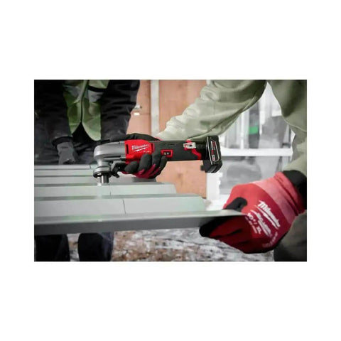 M12 Fuel 16 Gauge Variable Speed Nibbler used on metal sheet, demonstrating fast, clean cuts in a construction setting.