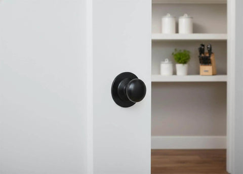 Matte Black Escutcheon Back Plates For Cabinet Knobs And Doors Four Pack Round Rosette Plate Two And One Third Inch Heavy Duty Die Cast Zinc Ideal For Bifold Closet Doors Door Pulls And Handles installed on a white door