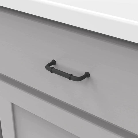 Matte black cabinet pull installed on gray drawer, part of 10 Pack Solid Core Cabinet Pulls Matte Black Cottage Collection 3 Inch Center To Center Hardware.