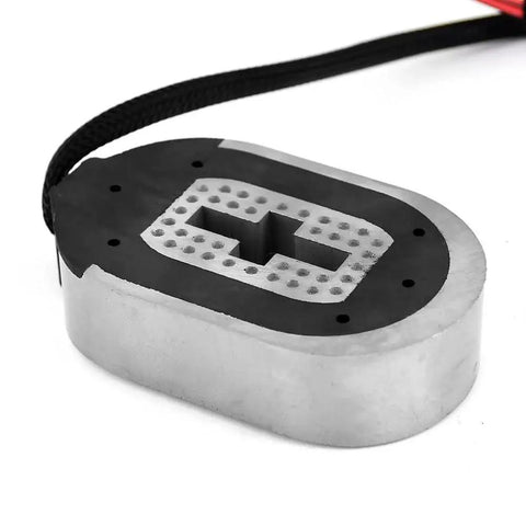 Top view of electric trailer brake magnet kit; oval metal housing with black pad and braided cable