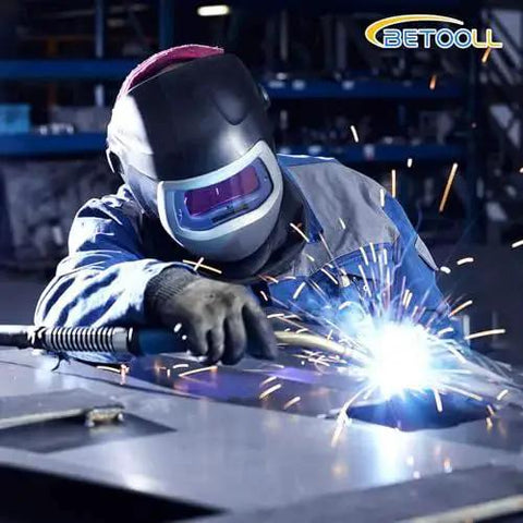 Welder using Argon Regulator For Welding With 6.6Ft Hose And CGA580 Fitting, sparks flying during MIG-TIG welding process.