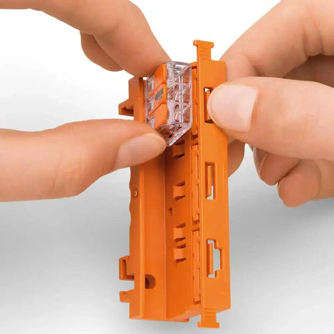 Go To Connection Terminal Set With 225 Pieces And 4 Mounting Adapters For All Conductor Types in hand showing quick clamp system.