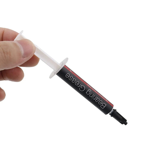 Hand holding syringe of Pro Grade High Performance Spindle Lubricant Oil And Bearing Grease for PC fans and motors