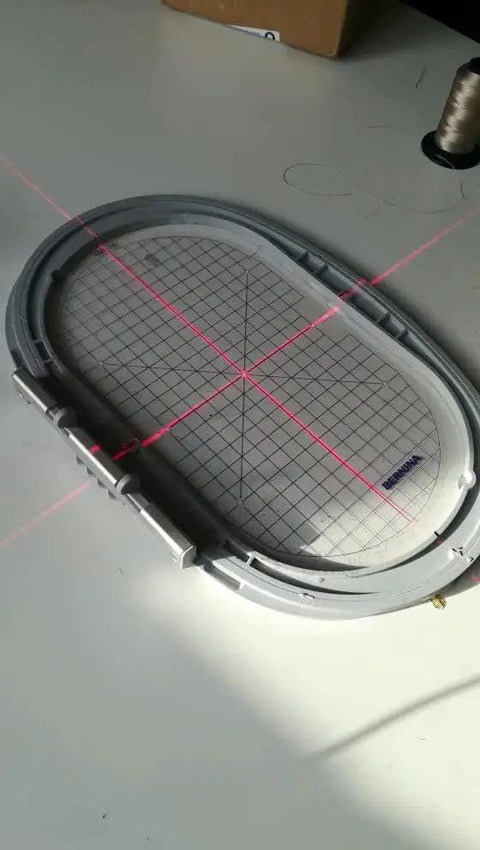 Red Cross Line Light Cross Hair Module for fabric alignment, showing 638 nm red beam, 16mm dial, and adjustable line width over fabric frame.