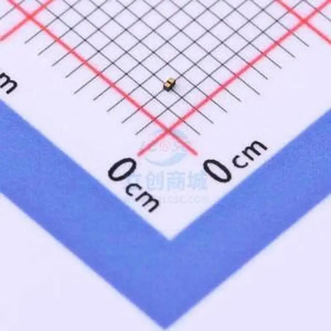 Close-up of ESD Protection Diode 50 Pack For Electronics, DFN0603-2 Package, small diode on graph paper, ESD7381MUT5G surface mount.