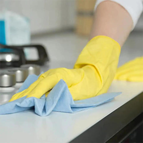 Person cleaning surface with blue shop towel roll, part of 55 count bulk pack for auto shops and garages, durable and absorbent.