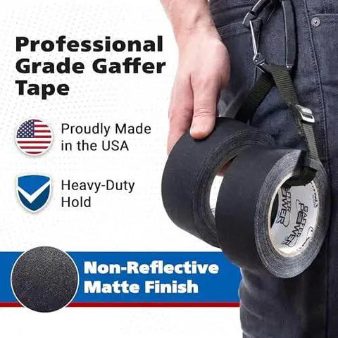 Man holding a roll of Professional Gaffer Tape 2 Inch By 30 Yard Non Reflective Heavy Duty Black with USA flag and matte finish details.
