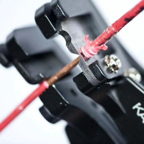 Close-up of Heavy Duty Automatic Wire Cutter and Stripper removing insulation from wire, showing blade action.