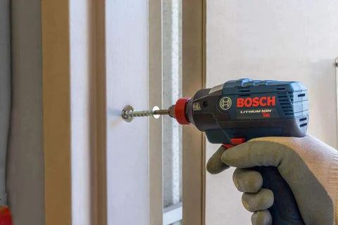 THDB25234CS Titen HD 1/4 Inch By 2-3/4 Inch Zinc Plated Countersunk Head Heavy Duty Screw Anchor being used with a drill on a door frame