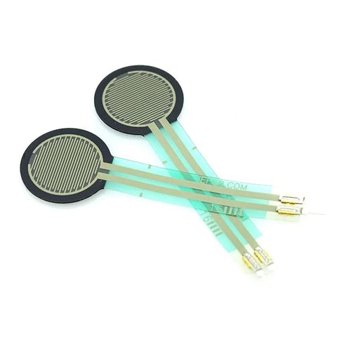 Two circular FSR force-sensing resistor discs on flexible green film with gold terminal leads for Arduino projects