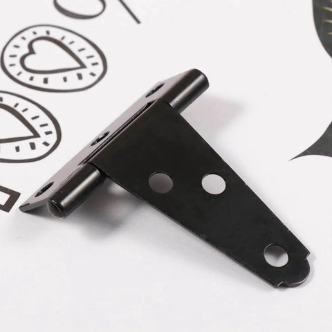 Close-up of a black T-shaped hinge on white background with three screw holes visible.