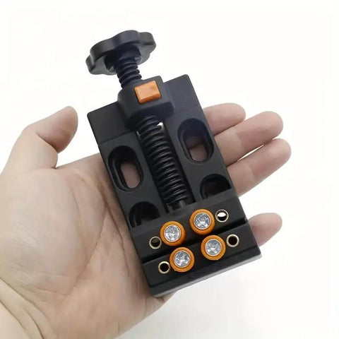 Hand holding mini drill press vise clamp for DIY jewelry and watch repair, walnut core bench vise for crafting and carving.