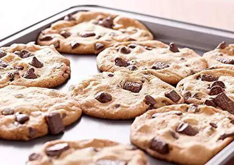 Freshly baked cookies on a Perforated Aluminum Sheet Pan 13 Inch By 18 Inch Half Size Heavy Duty Workhorse Commercial Bakeware.