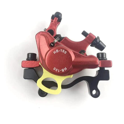 HB-100 red aluminum MTB hydraulic disc brake caliper, side view with yellow mounting adaptor and black hardware