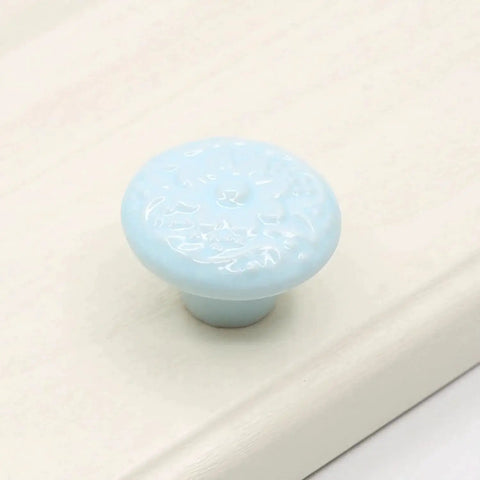 Light blue ceramic mushroom cabinet knob from the 15 Piece Ceramic Mushroom Cabinet Knob Set With 3 Size Mounting Screws Glossy Vintage Dresser Drawer Cupboard Pulls For Furniture DIY Wardrobe Solid Color Hardware Easy Install Durable Alloy Core on a white surface