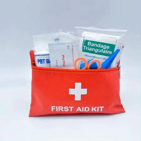 Grab-And-Go Compact Travel First Aid Kit with 95 Piece Emergency Set, red pouch showing bandages and scissors, ultra lightweight.