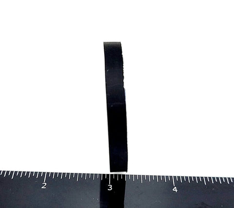 Side view of Two Inch Wide Round Silicone Rubber Bumper Feet One Quarter Inch Thick Adhesive Backed Pads against ruler.