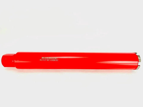 Pro Grade Heavy Duty 2.5 Inch Wet Core Drill Bit For Concrete Rebar Asphalt Brick And Masonry With One And One Quarter Inch Threaded Shank Seventeen Inch Overall Length Wet Barrel Core Bit For Hole Drilling And Barrel Coring By BLUEROCK Tools, side view of red drill bit