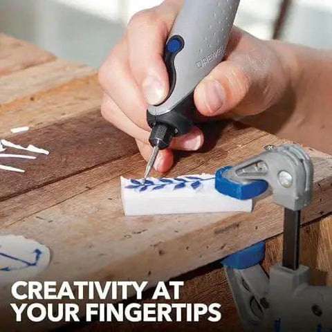 Person using Versatile 120V Rotary Tool Kit With 15 Accessories For Wood Carving, Glass Engraving, And Jewelry Making, Quiet Yet Powerful Engraving Pen For Home Crafting And DIY Projects With A 6 Foot Cord on a wooden piece.