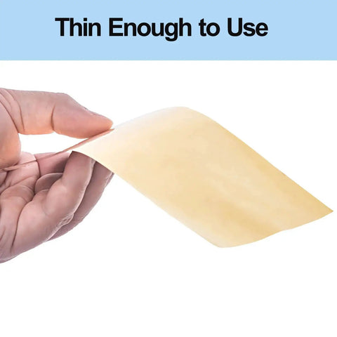 Person holding a thin sheet of Brass Shim Stock Assortment Set 6 Inch By 4 Inch For Home Shop Projects, Five Thicknesses 0.001 0.002 0.003 0.005 And 0.01 Inch, Polished Brass Sheets, Handy For Jewelry Making, Model Building, And Repairs.