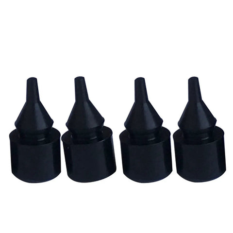 Close-up of four black rubber bumpers from the Eight Piece Fuel Tank Filler Door Rubber Bumper Set For GM Trucks And SUVs.