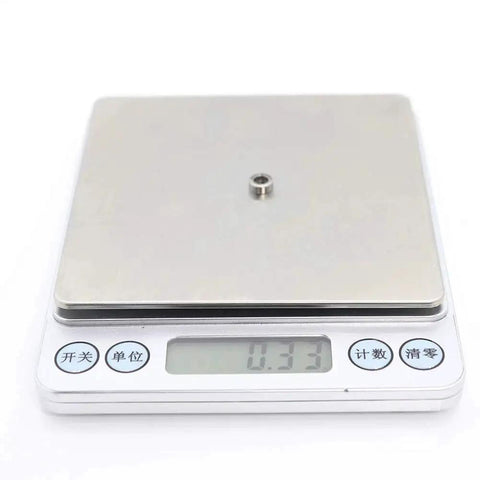 Beefy Ten Pack Shielded Miniature Ball Bearings 4x7x2.5mm MR74ZZ ABEC Five Chrome Steel weighing on scale