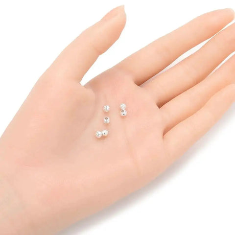 Hand holding 500 Pcs 4mm Sterling Silver Plated Brass Corrugated Round Bead Spacers For DIY Jewelry Making Craft Supplies Set CF10-4