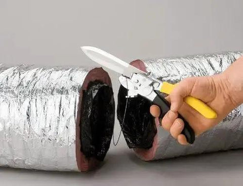 Hand holding FDC3 Flex Duct Tool Beast Of A Multi Purpose Cutter With Built In Wire Cutter And Double Edged Knife Blade near flex duct