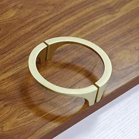 Two Pair Cabinet Hardware Handles In Golden Copper Brushed Gold Finish On Wooden Surface