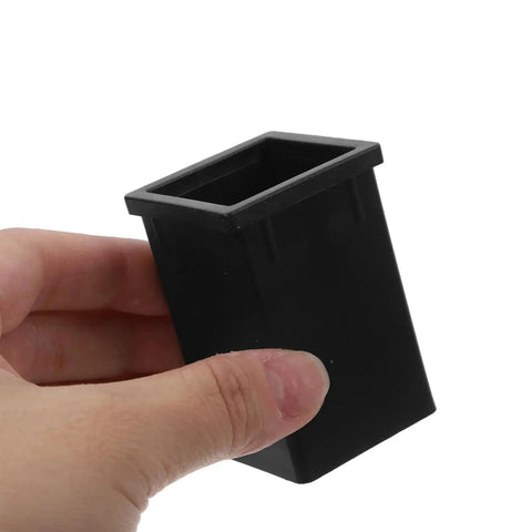 Black plastic TEHAUX square-tube connector sleeve for 1.57 x 2.36 in square tubing, held in hand