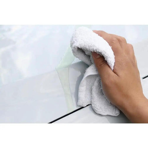 Virgin Terry Cotton Towels Pack Of 60, 14 By 17 Inches, White, used for cleaning, showing hand wiping surface with white towel