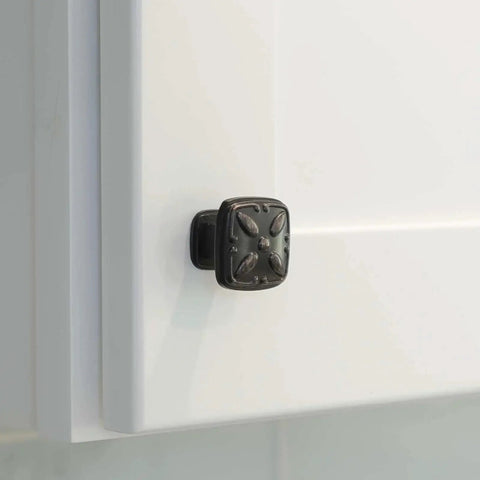Close-up of solid zinc alloy cabinet pull knob, oil rubbed bronze, installed on white cabinet door, 1-1/8 inch size, 10 pack.