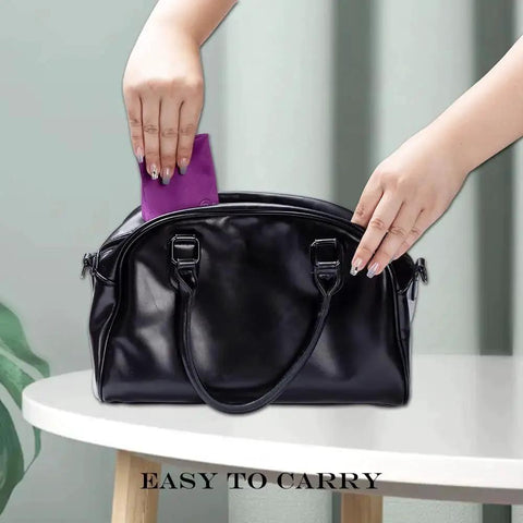 Person placing microfiber cloth for glasses and screens into black bag