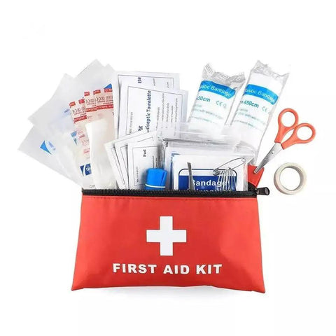 Grab-And-Go Compact Travel First Aid Kit With 95 Piece Emergency Set in red pouch with bandages, scissors, and tape.