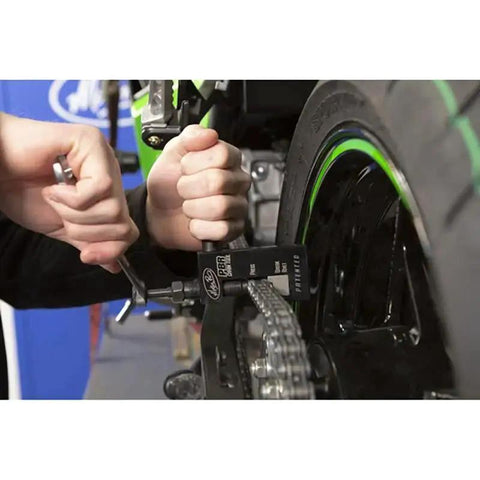 Person using All In One Chain Tool For 520 525 And 530 Chains That Presses Breaks And Rivets With A Built In Storage Case on motorcycle chain.