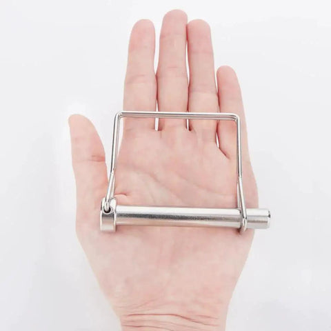 Front view: hand holding a 316 stainless steel square PTO shaft locking pin, 3/8 x 2-3/4 in