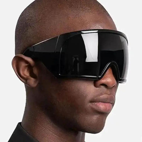 Side view of Wraparound Oversized Sunglasses For Women And Men Dope Futuristic Rave Style Shield Sun Glasses With Big Curved Lenses Ultra Bold Frame UV Protection Trendy Black Shades For Everyday Edge on a person.