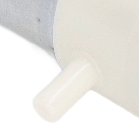 Miniature vacuum pump component, white plastic connector with a T-shaped knob, close-up view