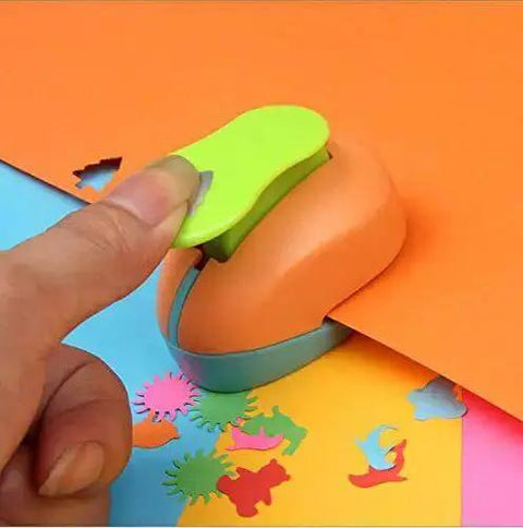 Hand using Spring Action Five Eighth Inch Circle Paper Punch For Crafting, cutting shapes from orange paper